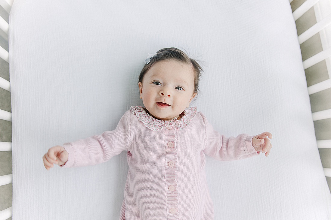 baby lays in crib during in-home newborn photo session with Sara Sniderman Photography in Norwood Massachusetts