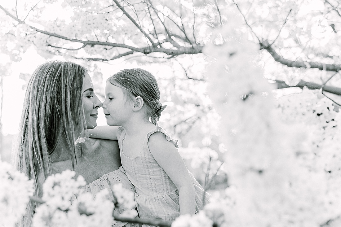 black and white of mom and daughter rubbing noses during family photo session with Sara Sniderman Photography at Wellesley College. 