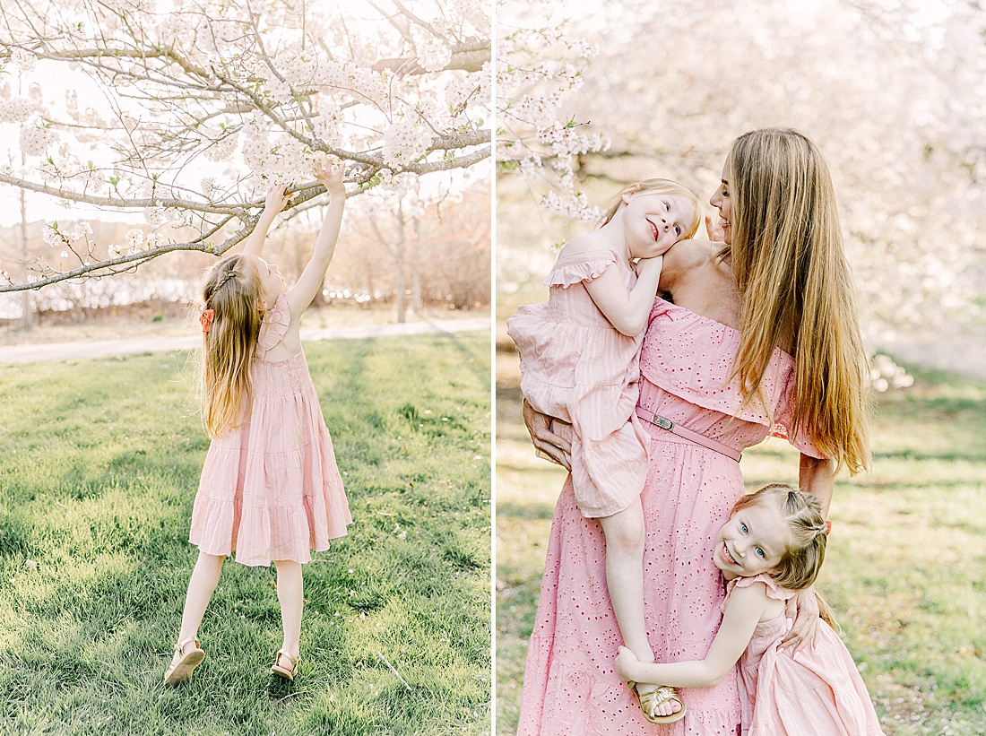 mom holding one daughter while other daughter hugs her leg during family photo session with Sara Sniderman Photography at Wellesley College. 