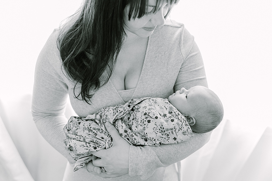 black and white photo of mother holding baby during newborn photo session with Sara Sniderman Photography in Wellesley Massachusetts