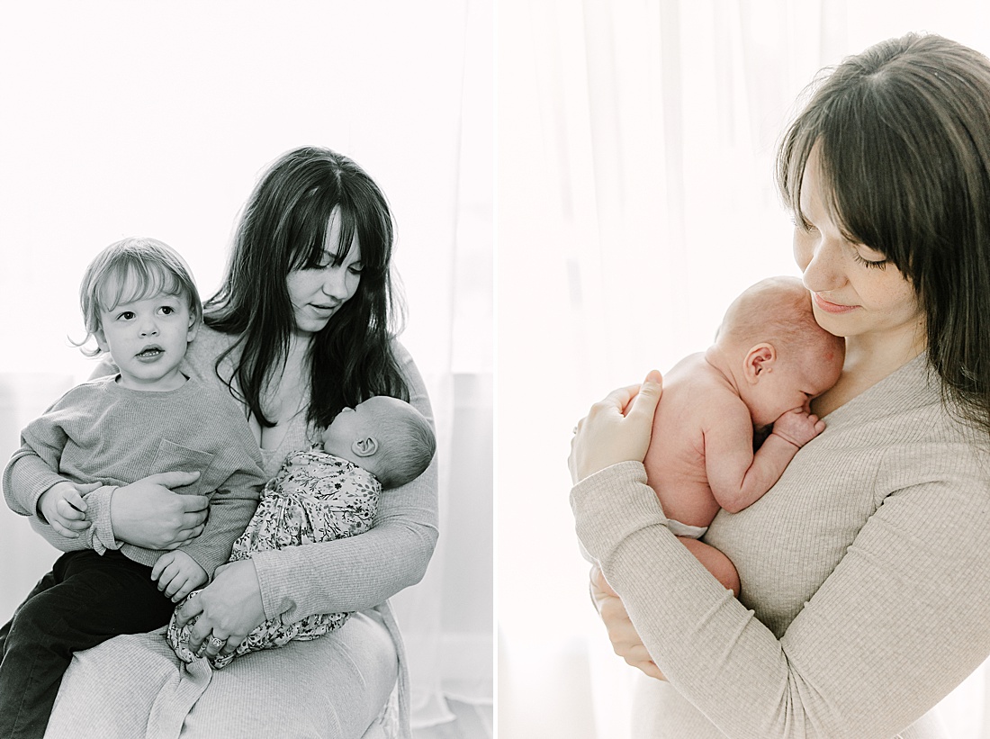 black and white photo of mother holding toddler and newborn during newborn photo session with Sara Sniderman Photography in Wellesley Massachusetts