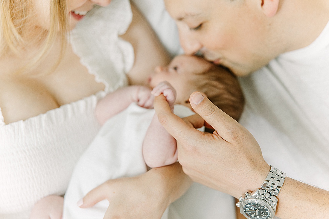 baby hold dads finger during in-home newborn photo session with Sara Sniderman Photography in Natick Massachusetts