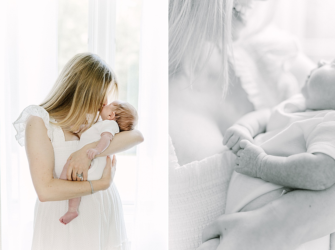mother stand by window holding baby during in-home newborn photo session with Sara Sniderman Photography in Natick Massachusetts