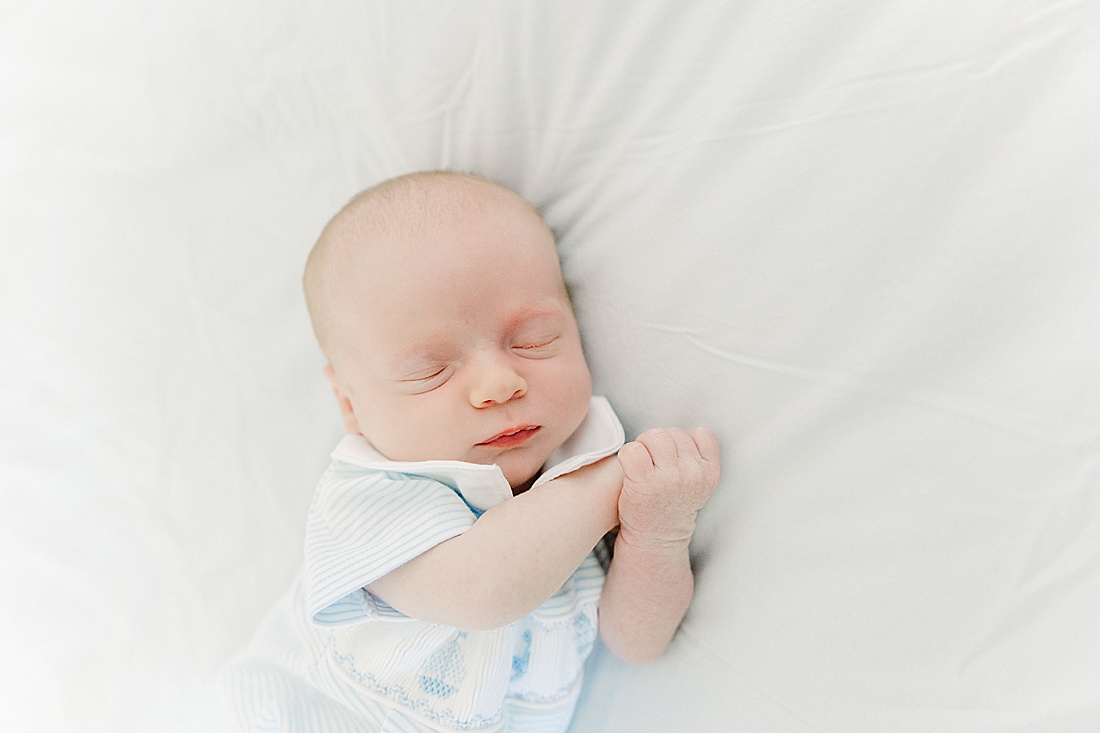 baby sleeps on bed during in-home newborn photo session with Sara Sniderman Photography in Wellesley Massachusetts. 