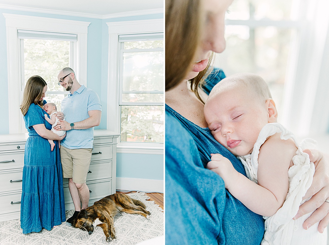 parents hold baby as dog lays on the floor during in home newborn photo session with Sara Sniderman Photography in Metro West Boston. 