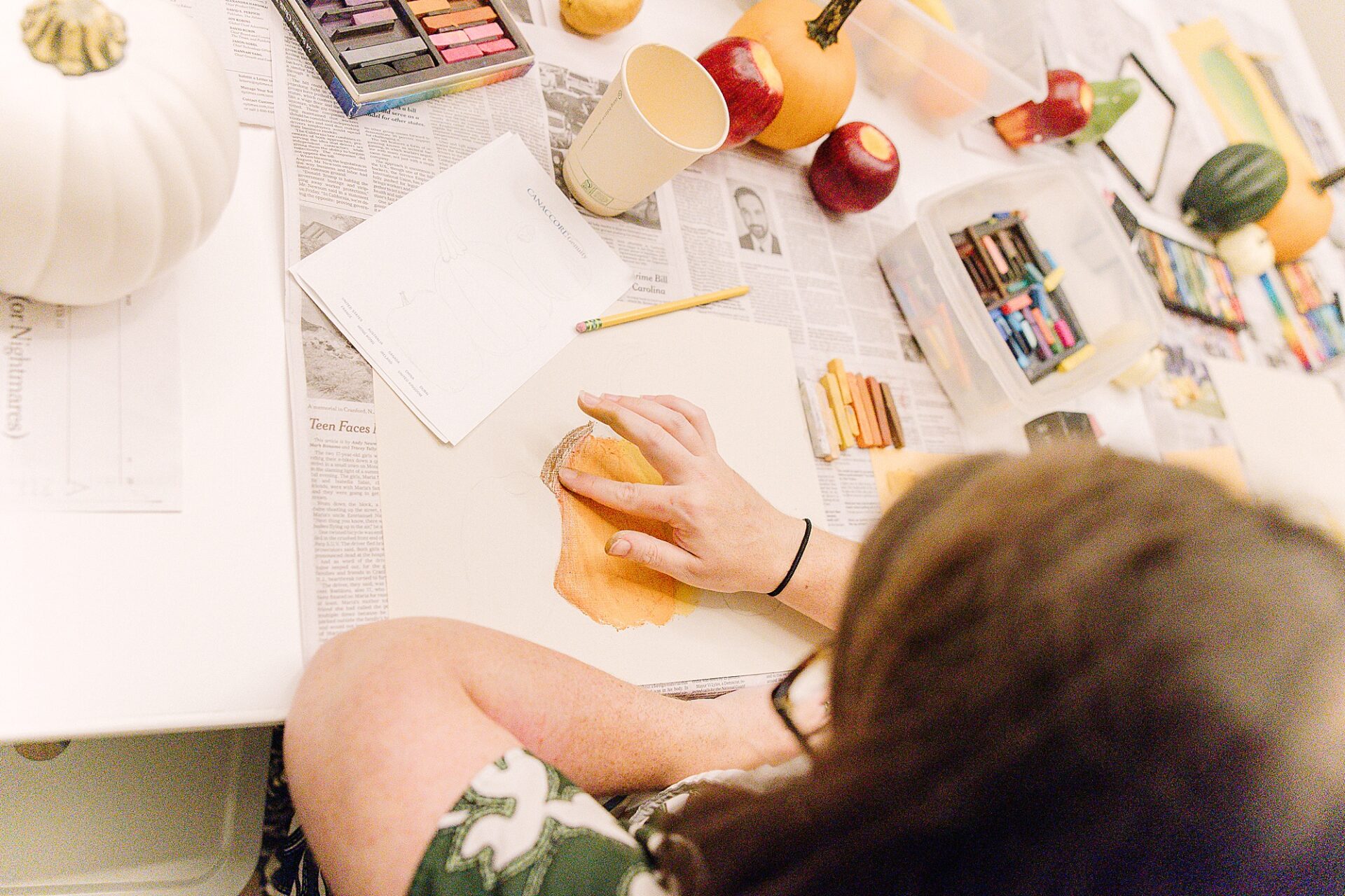 woman using hand to blend pastel crayons during art class at Bloom and Grown in Natick Massachusetts