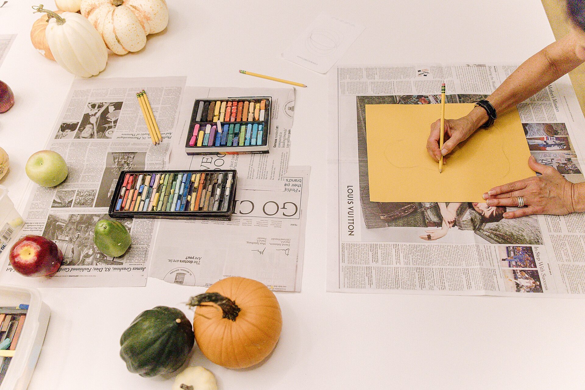 pumpkin, crayons and womans hand writing during art class at Bloom and Grown in Natick Massachusetts