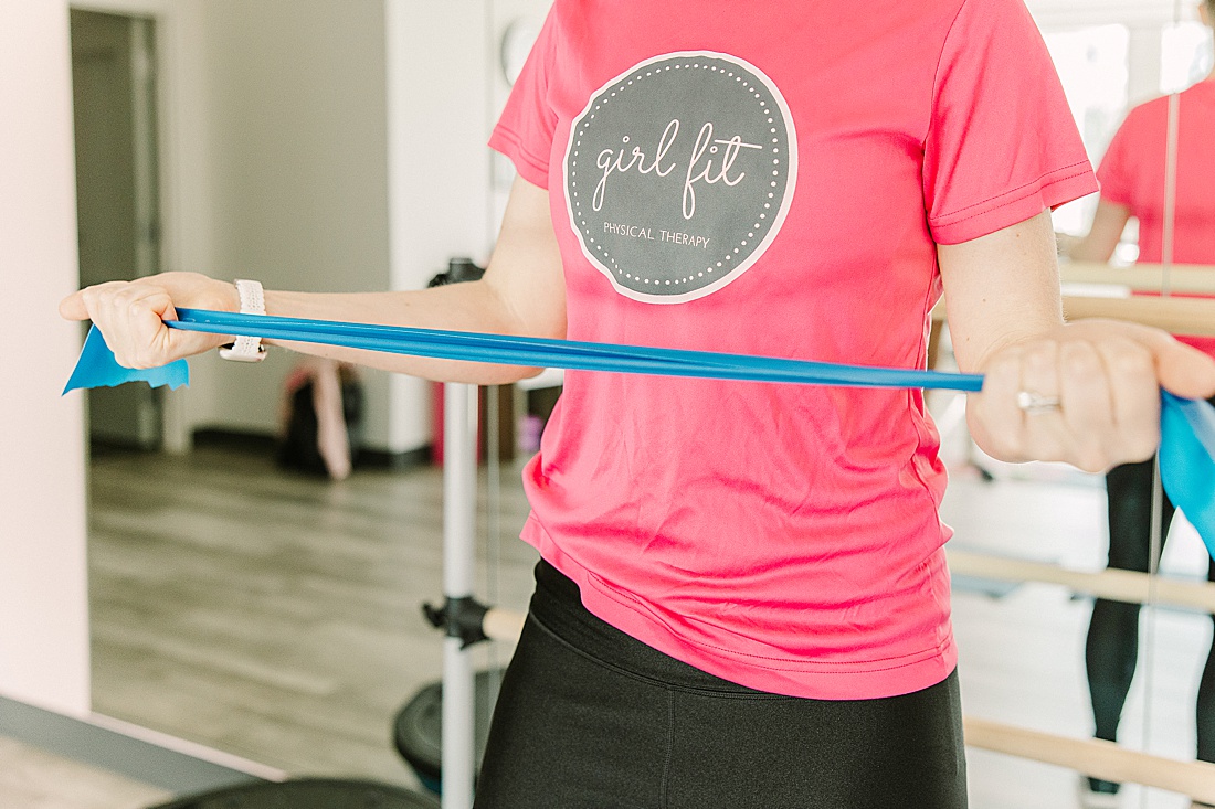 woman using resistance band at girl fit physical therapy in framingham massachusetts