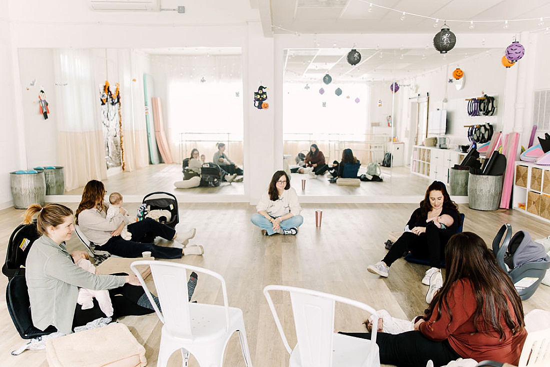 moms sit in circle on the ground during Chickadee and Hen Post partum mom group at DanceFit Natick Massachusetts