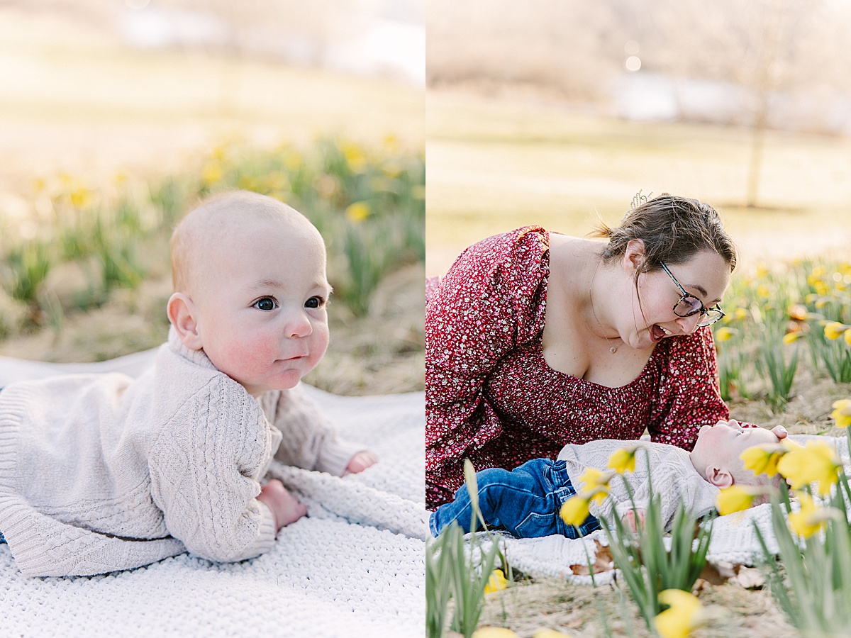 baby sits on blanket in field of flowers during spring family photo session with Sara Sniderman Photography in Wellesley MA
