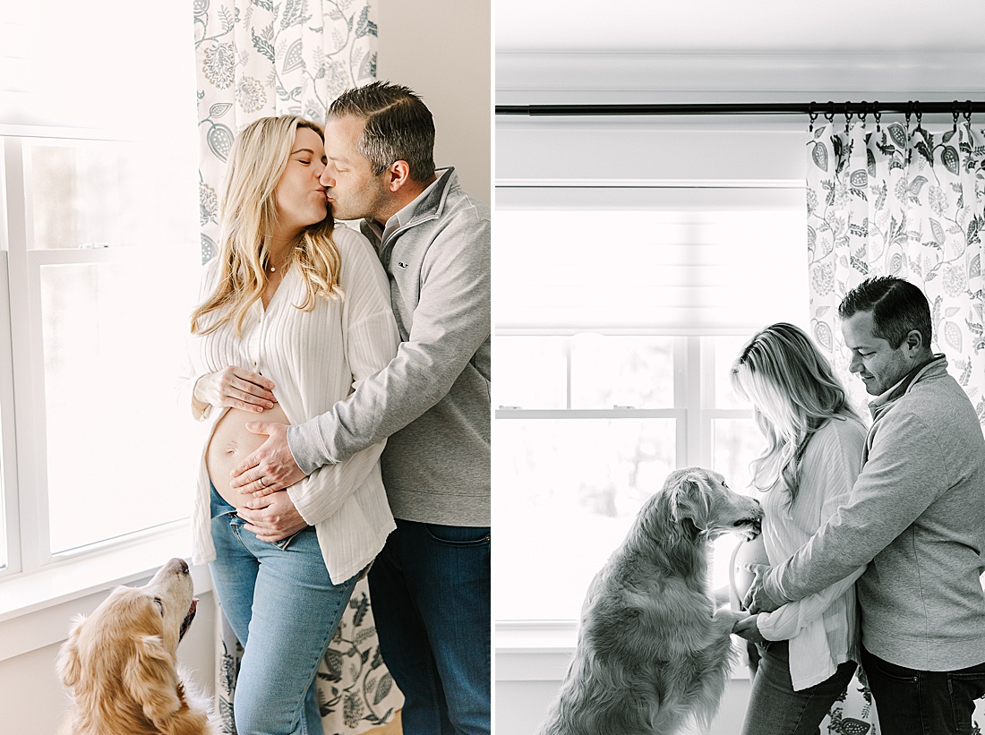 couple kisses while dog looks at them during in home maternity photo session with Sara Sniderman Photography in Holliston Massachusetts